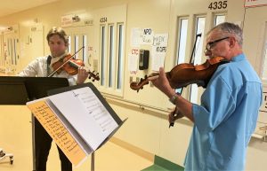 Violin players, one staff and one incarcerated, perform at San Quentin Rehabilitation Center.