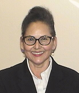 Leticia Tellez smiling and wearing glasses.