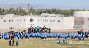 Centinela State Prison X-Fest with a large group of incarcerated people gathering around a stage.