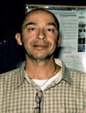 Rigoberto Arias smiling while looking at the camera.