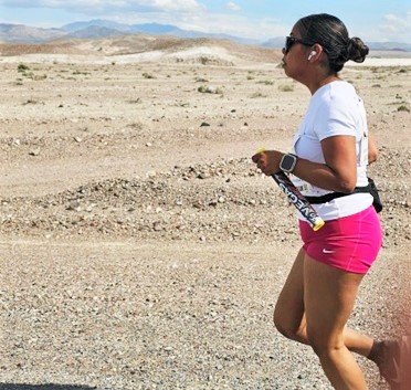 A female correctional officer runs across desert in Baker to Vegas Relay.
