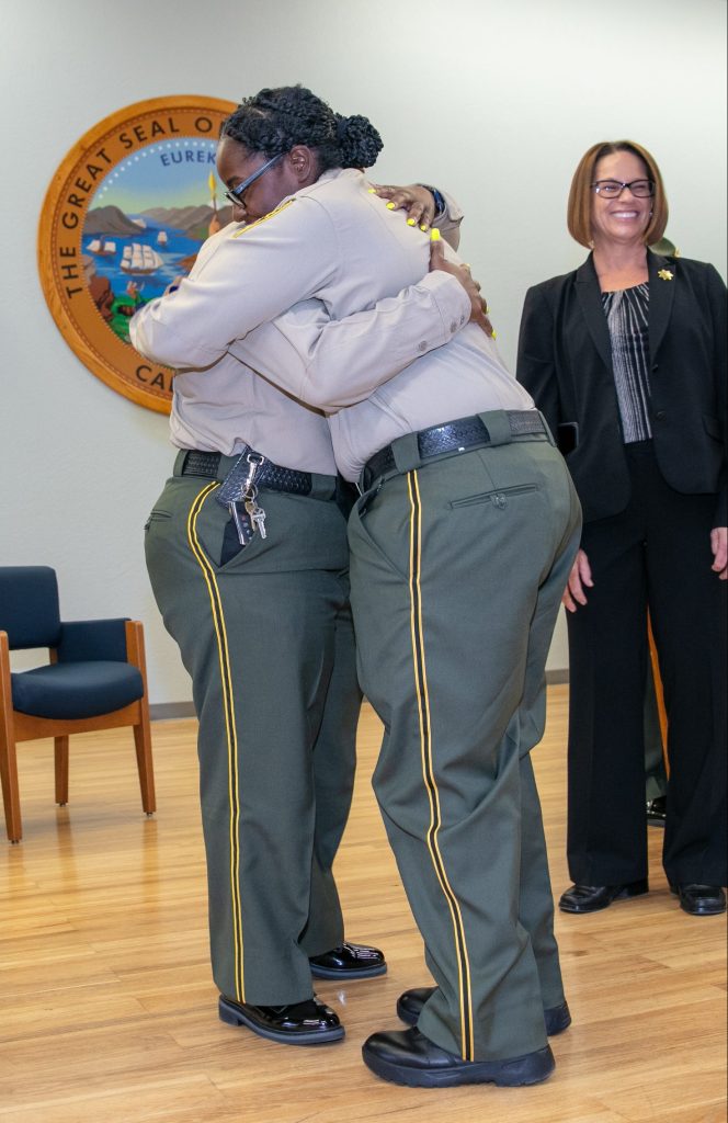 A mother hugs her daughter as she graduates the Basic Correctional Officer Academy in Galt.
