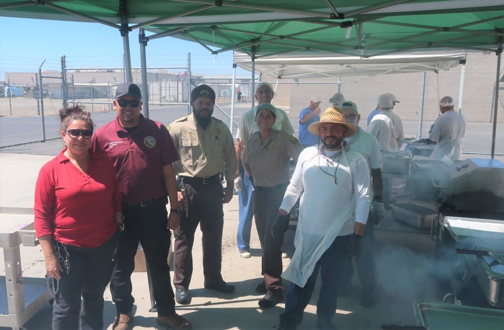 Staff and population working together to BBQ