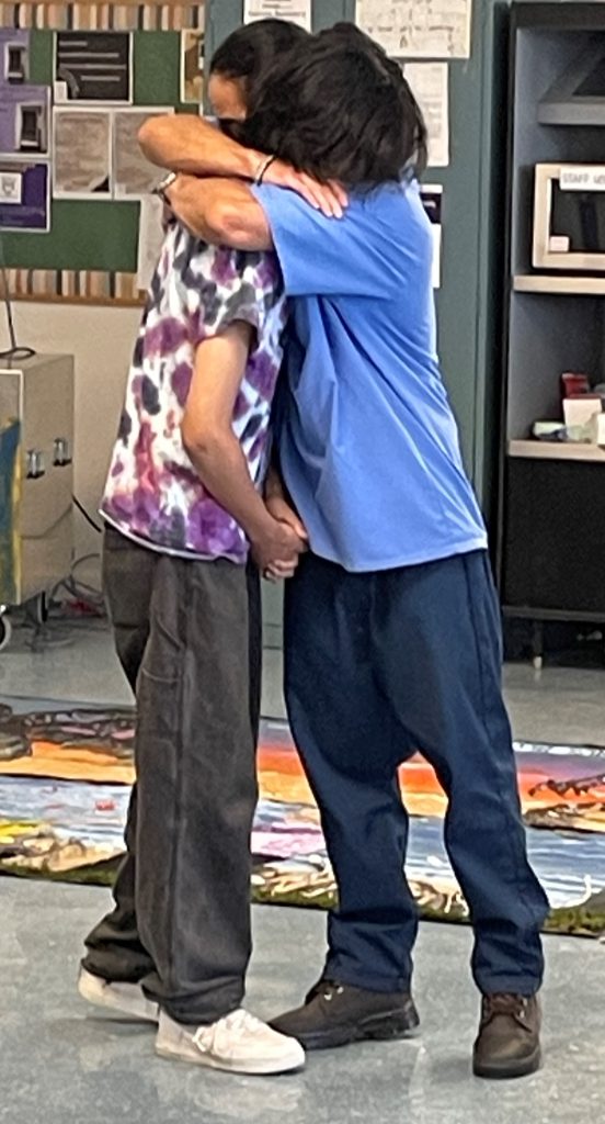 incarcerated member hugs their child at Camp Grace