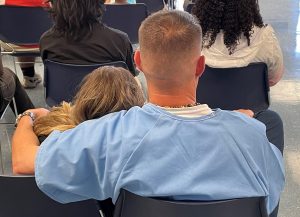 incarcerated man holds daughter in his arms