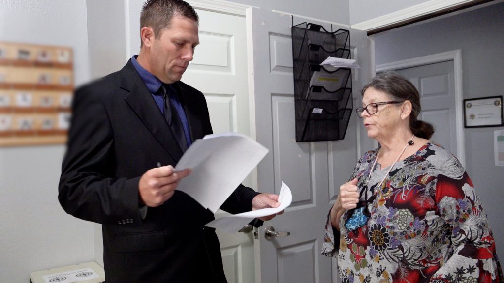 man in suit speaking to DAPO Ms. Mitchell
