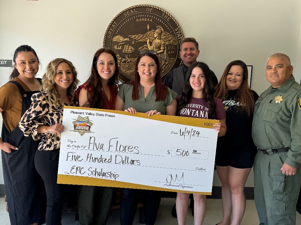 Flores family receiving check at PVSP