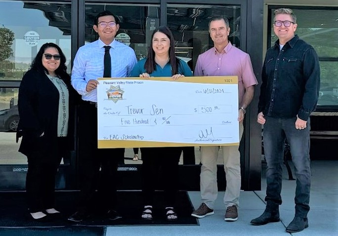 Martinez family receiving check at PVSP