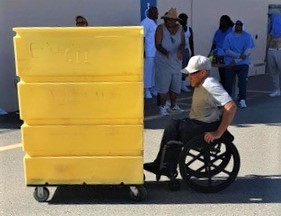 incarcerated in wheelchair pushing bin