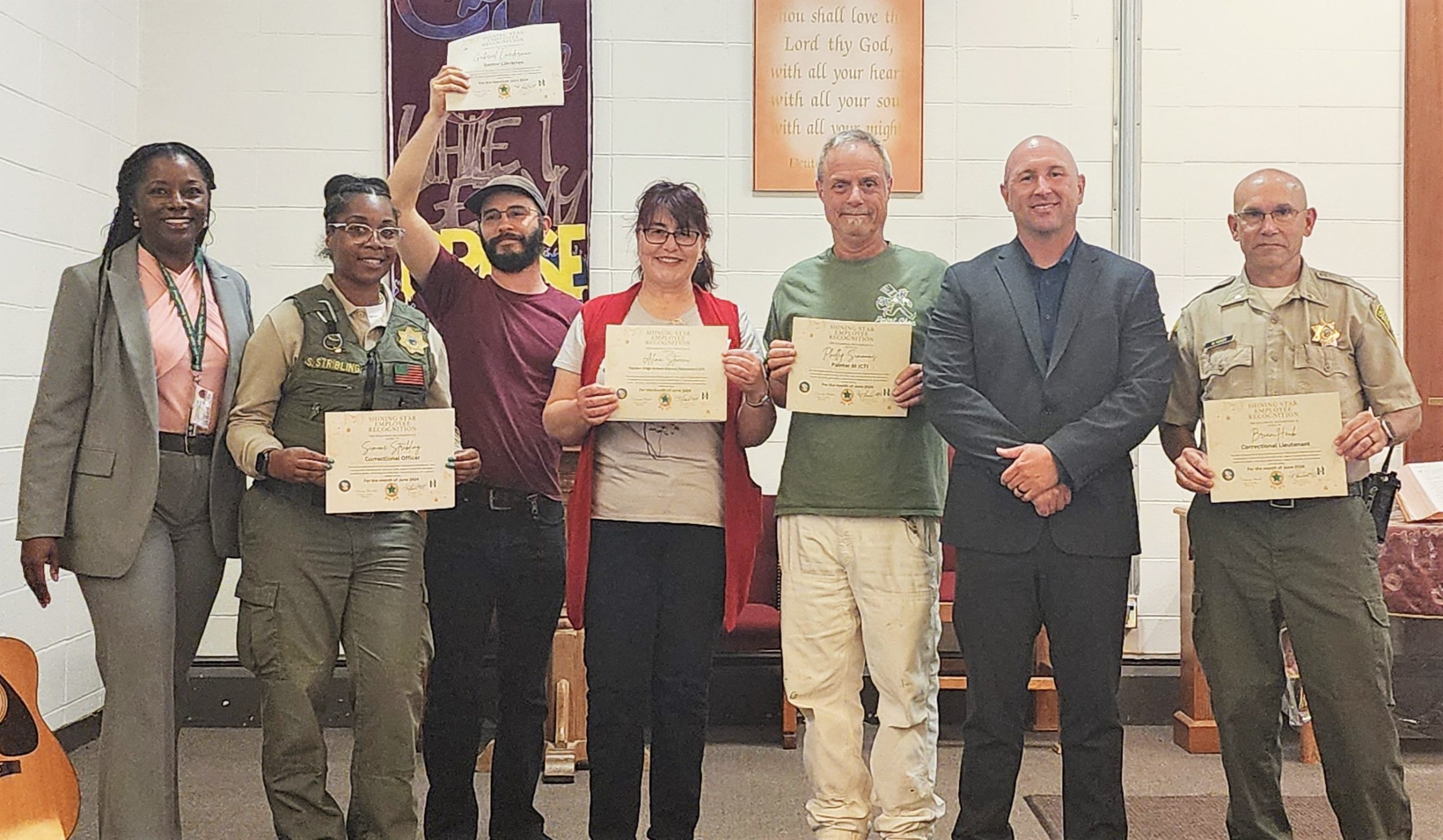 Group photo of Shining Star Awards recipients with warden and chief executive officer at San Quentin Rehabilitation Center.