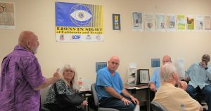 Eyeglasses program manager speaks with a group at Avenal prison.