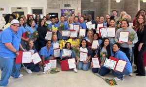 Peer Support Specialist Program graduates hold their certificates at Central California Women's Facility in Chowchilla (CCWF).