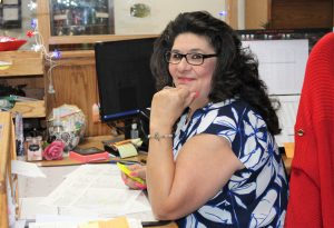 Centinela State Prison employee Josie Lizarraga sitting at her desk.