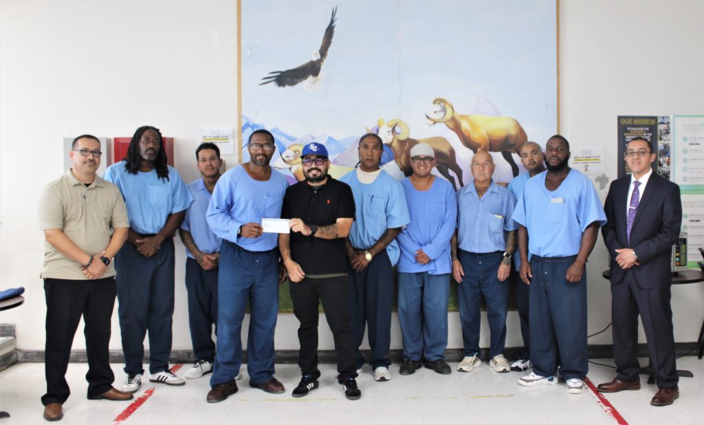 Incarcerated people present a check to youth sports at Centinela State Prison.