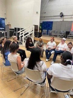 Group of women sitting in a circle in a female prison.