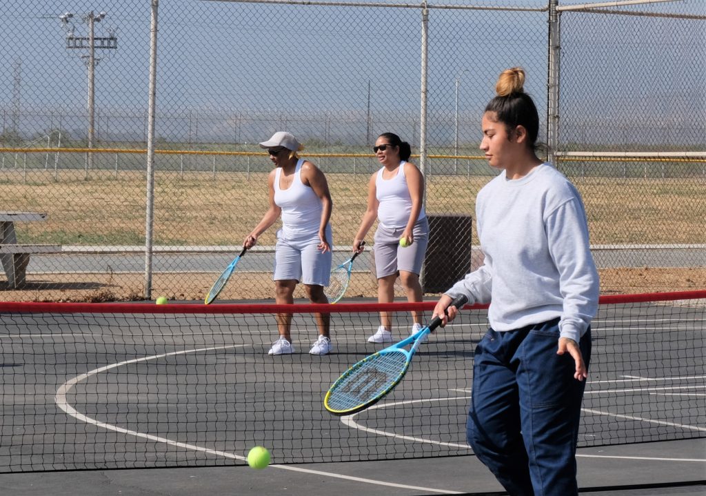 Tennis clinic at CIW with people learning the basics of the sport.