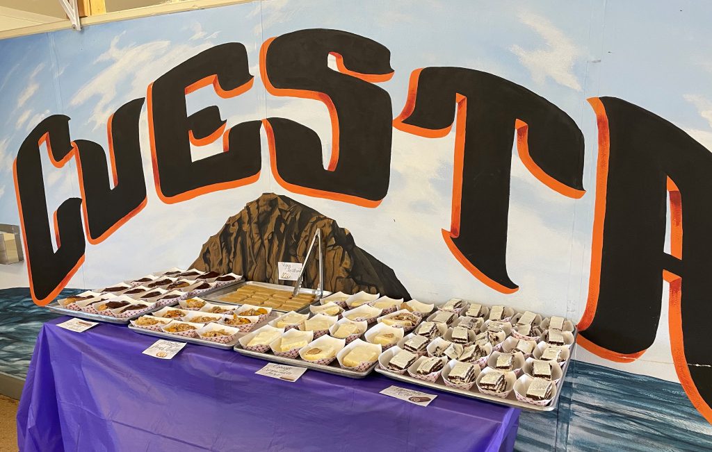 Table with food spread out and the word Cuesta above it, for Cuesta College.