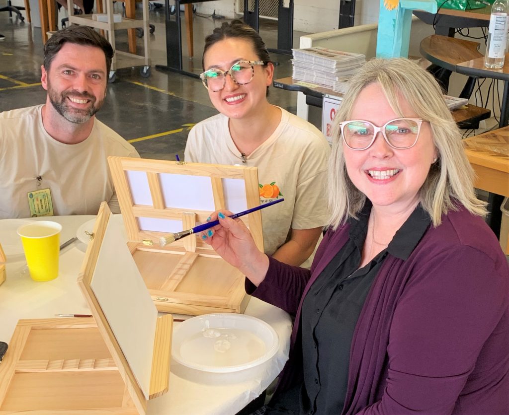 CMF employee and her family painting at a special event.