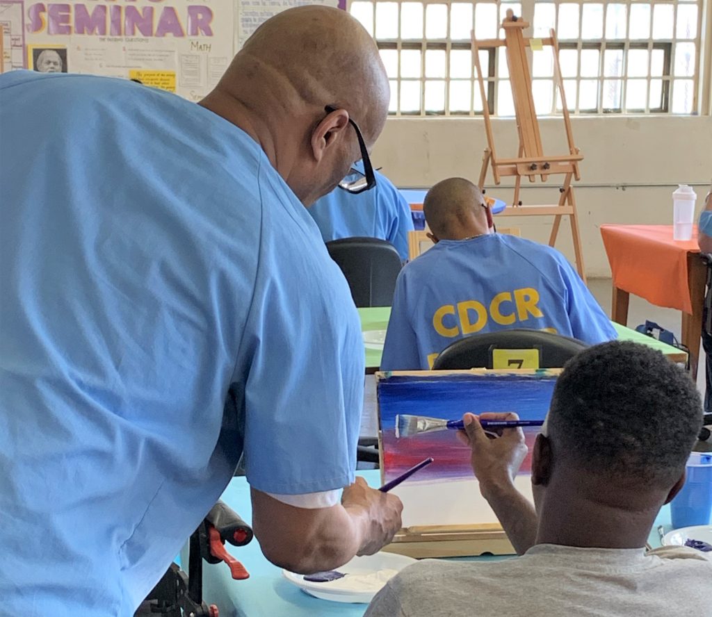 Incarcerated people painting as a fundraiser and rehabilitation effort.