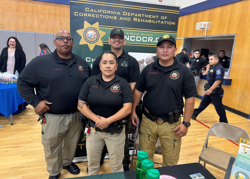 Four Correctional Training Facility staff volunteers at a CDCR information booth.