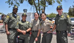 Correctional staff in uniform pose at an appreciation event at Mule Creek State Prison.