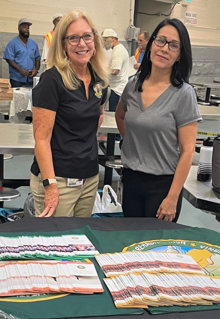 CDCR staff standing with brochures