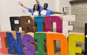 Two people with the words Pride Inside at RJD Correctional Facility.