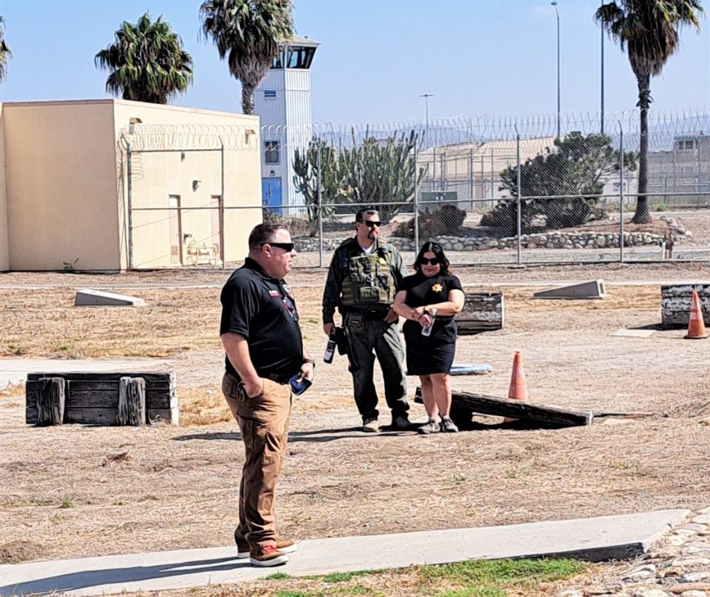 Staff on an empty prison yard. 