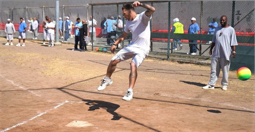 Incarcerated man jumps as he tries to a kick a ball at San Quentin.