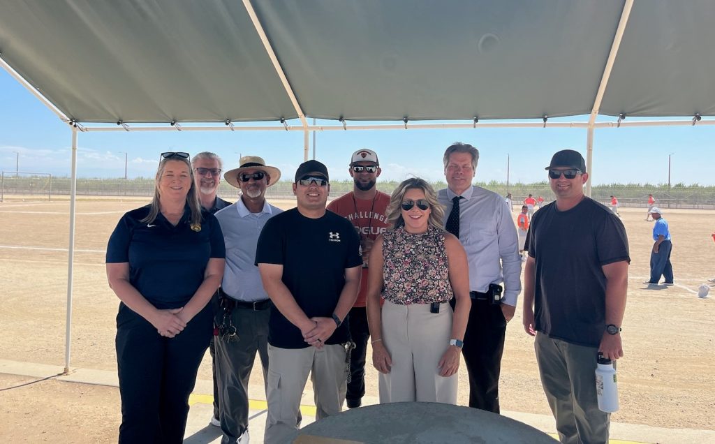 Staff and prison leadership at a softball game.