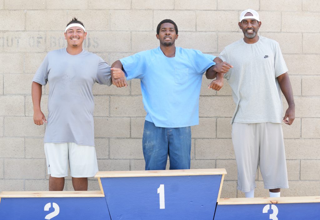 Three incarcerated me being recognized as the top-three winners of the shotput competition at Valley State Prison.