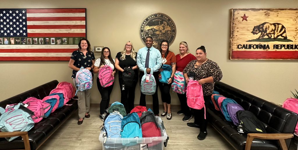 Staff at Valley State Prison with backpacks.