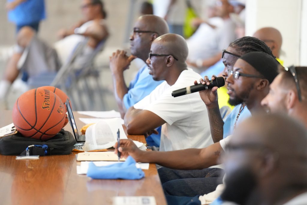 A man speaks into a microphone.