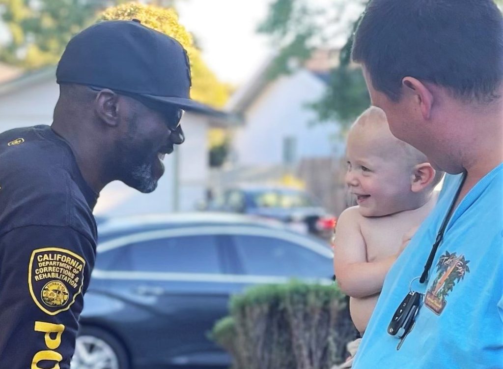 Parole agent smiles at a baby.