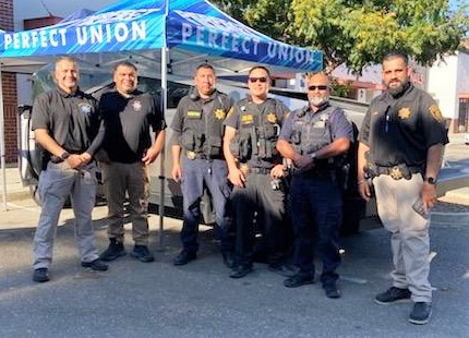 Woodland block party with officers and parole agents. 