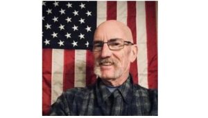 David Hawpe featured obituary image with US flag in the background.