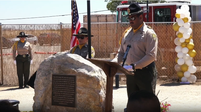 Honor guard with a memorial recognizing forced sterilizations in correctional facilities.