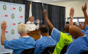 CALPIA General Manager Bill Davidson at a lectern during a graduation ceremony.