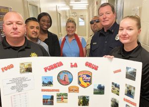 Staff and an incarcerated firefighter at a recruitment event at CCWF for the conservation camp program.