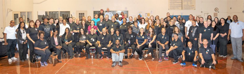 A group photo of people involved in the California Institution for Men reentry resource fair.