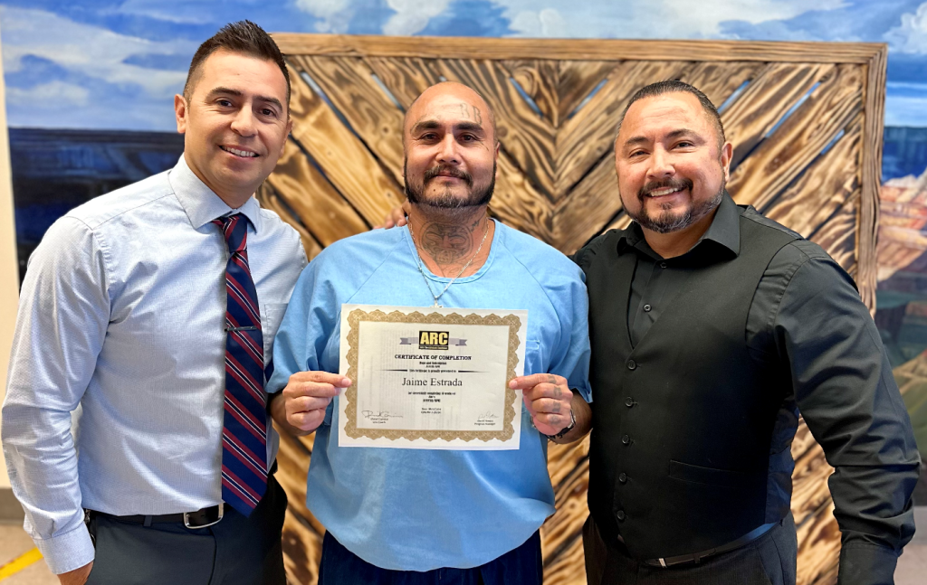 Anti-Recidivism Coalition graduate at CSP-Corcoran receives his certificate of completion from the associate warden and program facilitator. 