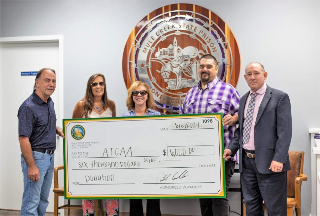 Mule Creek presents a fundraising check to a community organization. 