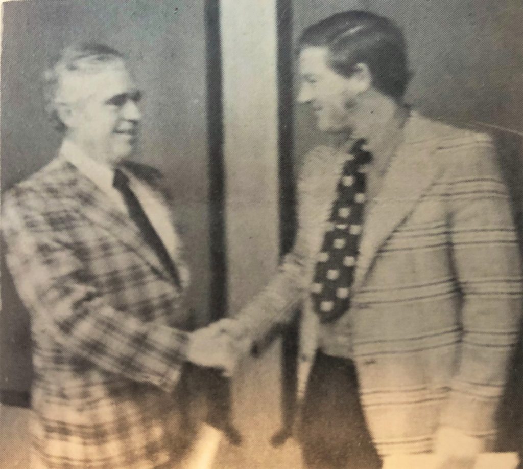 Ray Procunier shakes hands with Agent Northrup in this photo published in Newscam, the department newspaper in 1975.