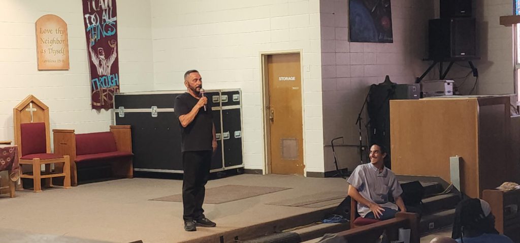 A comedian speaks to an audience of incarcerated people and staff at San Quentin.