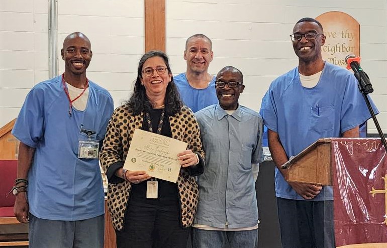A doctor with incarcerated people during the San Quentin Shining Star awards.