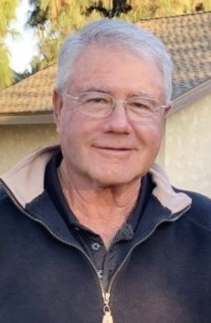 Smiling and relaxed Eugene Oliveira, obituary image.