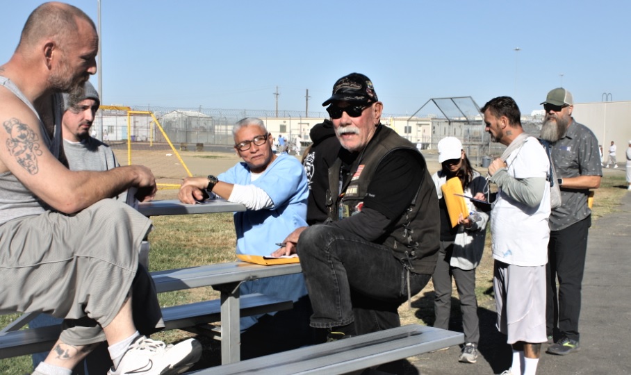 Incarcerated people speak with volunteers.