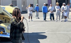 Avenal State Prison Bill Glass Day of Champions event shows a singer performing for incarcerated people.