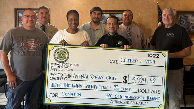Avenal staff holding check with rotary club