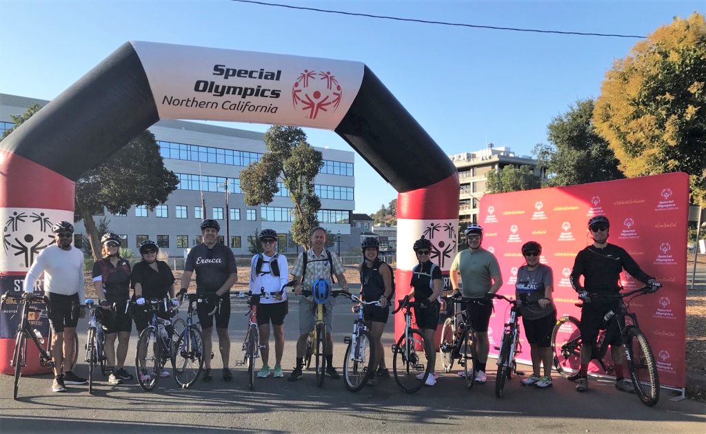 Cyclists under the Special Olympics Law Enforcement Torch Run arch.
